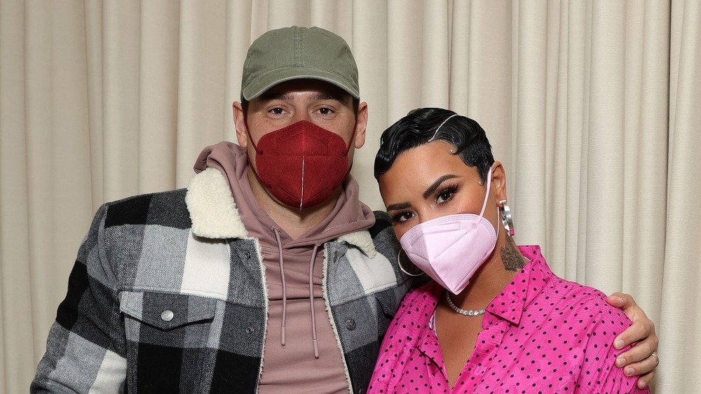 Scooter Braun and Demi Lovato wearing masks