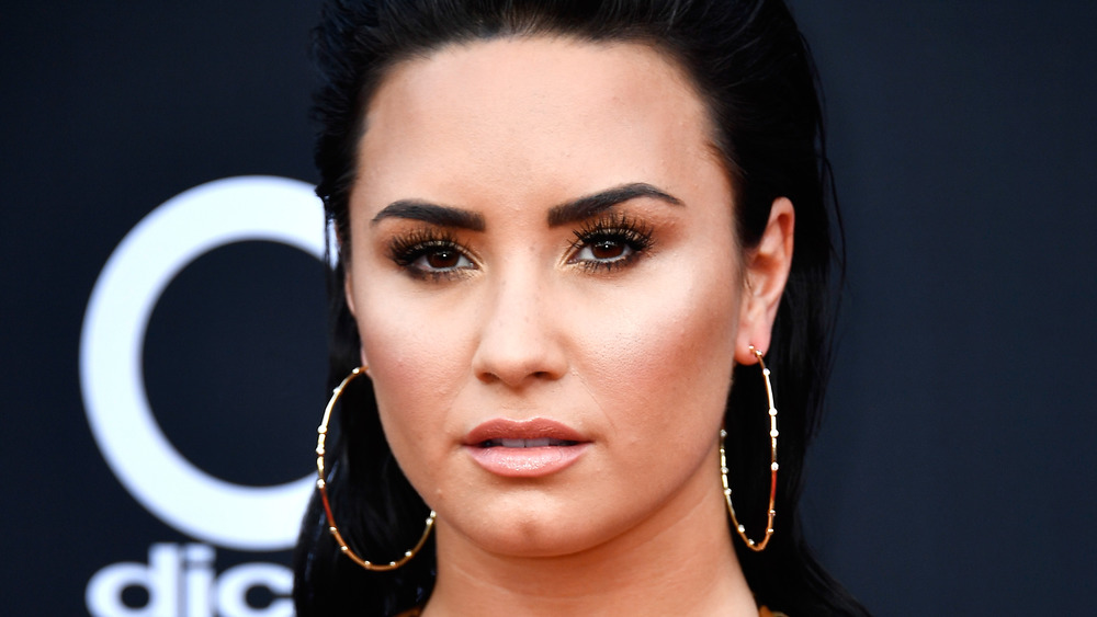 Demi Lovato with a neutral expression