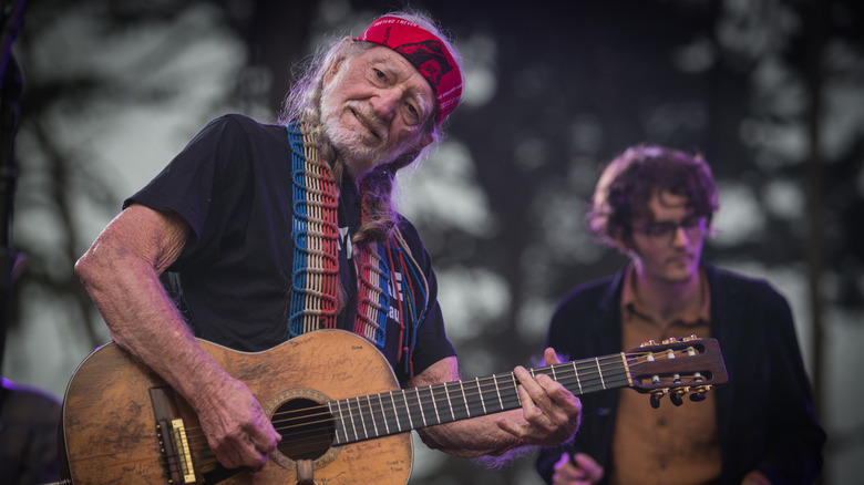 Willie Nelson playing guitar