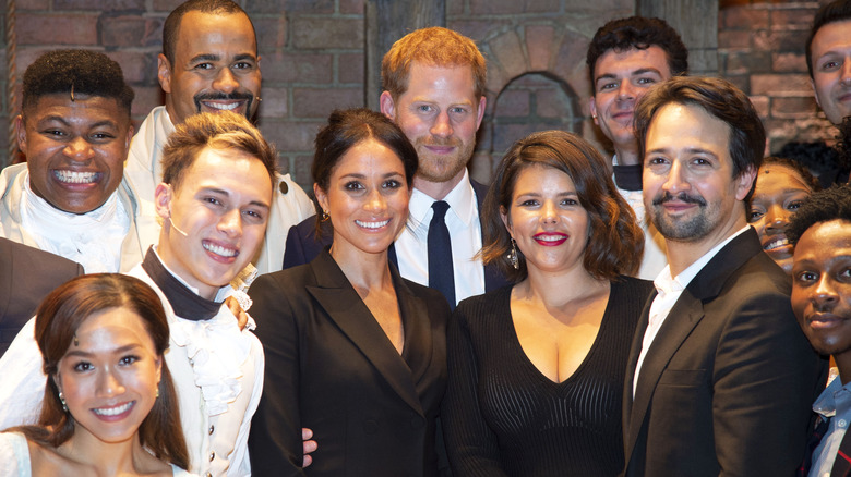 Prince Harry and Meghan Markle with group of people 2019