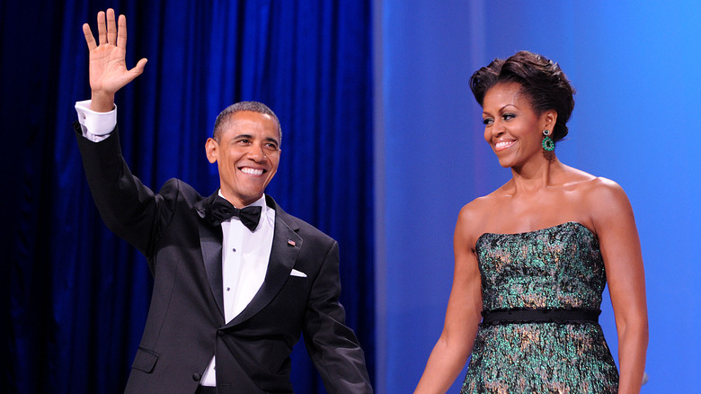 Barack Obama waving alongside Michelle