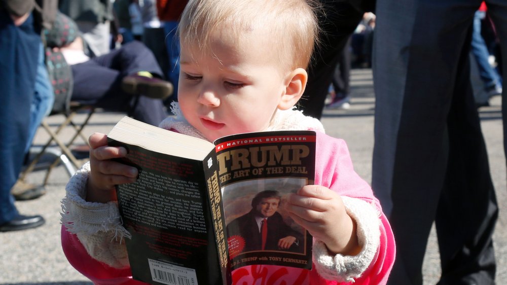 Baby reading The Art of the Deal