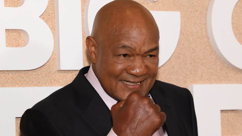 George Foreman smiling and holding up fist