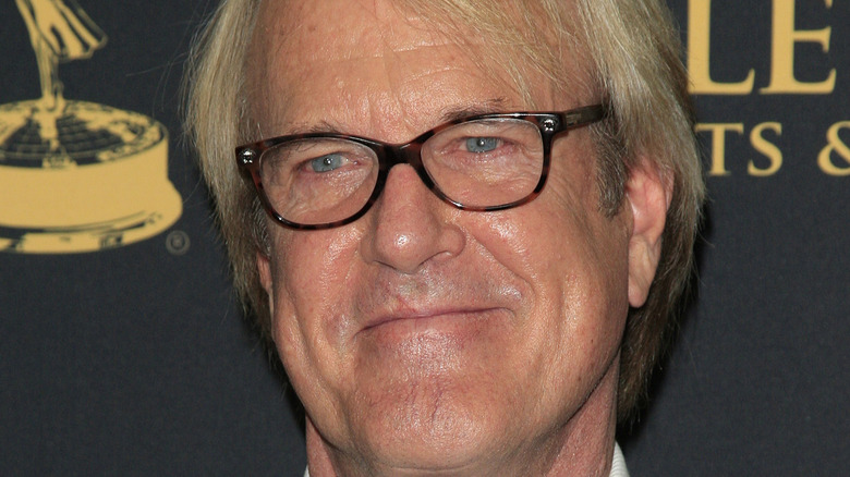 John Tesh with slight smile and glasses