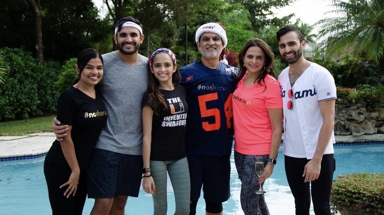 The Patel family posing poolside in Miami