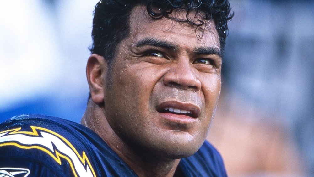 Junior Seau looking off to the side with a serious expression during a game