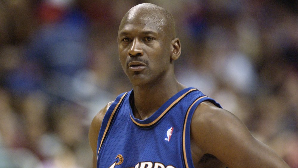 Michael Jordan in a Wizards uniform, looking serious during a game