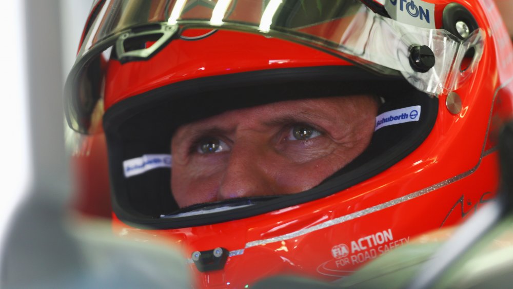 Michael Schumacher wearing a red helmet during a race