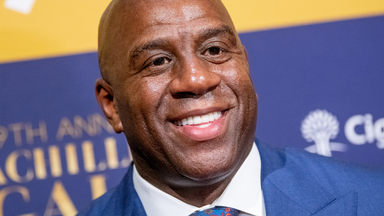 Magic Johnson in a blue suit