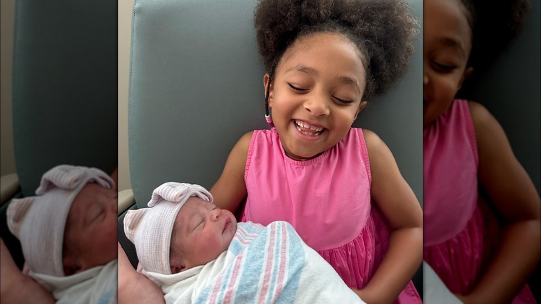 Alexis Olympia Ohanian holding Adira River