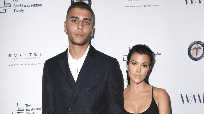 Younes Bendjima and Kourtney Kardashian pose together