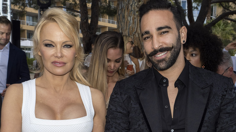 Pamela Anderson posing with Adil Rami