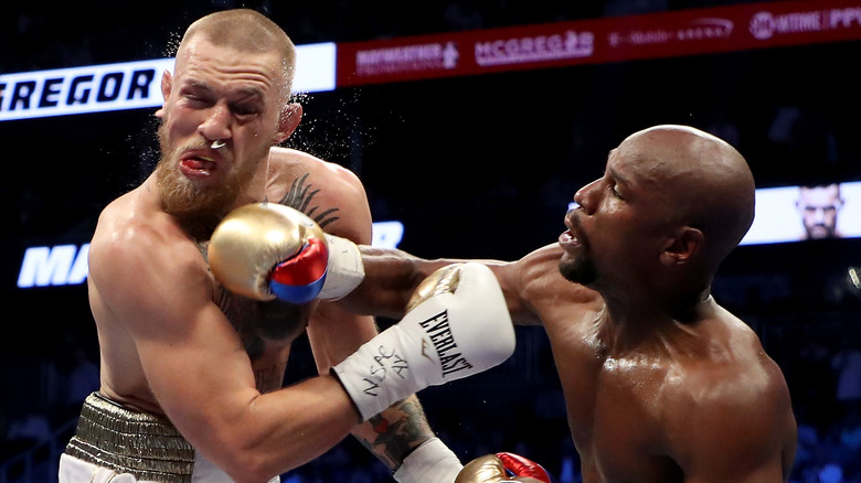 Conor McGregor punched by Floyd Mayweather