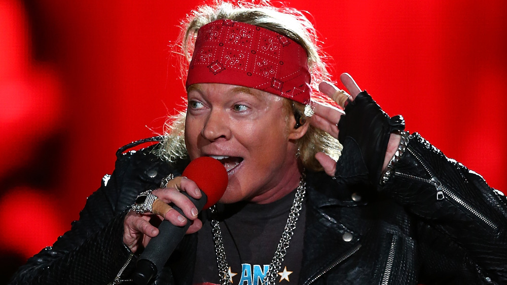 Axl Rose holding a microphone 