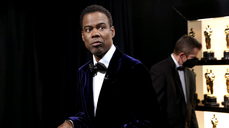 Chris Rock is standing backstage during the 94th Annual Academy Awards