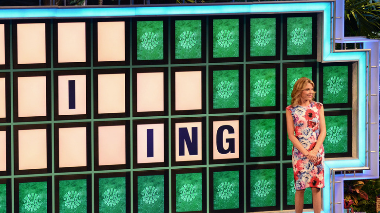 Vanna White standing on Wheel of Fortune set