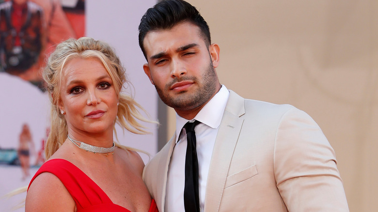 Britney Spears and Sam Asghari squinting