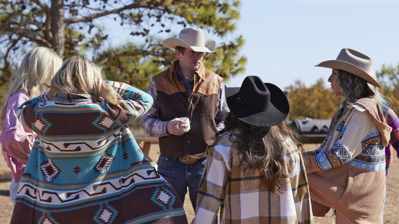 Farmer Landon standing with women