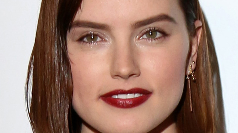 Daisy Ridley smiling with red lipstick
