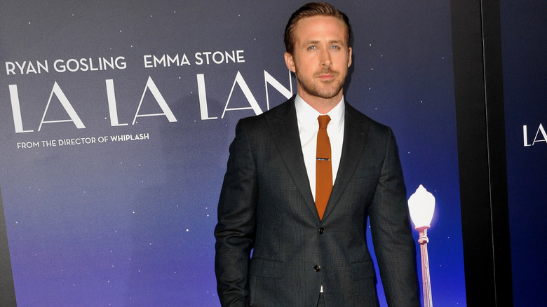 Ryan Gosling in front of a La La Land poster