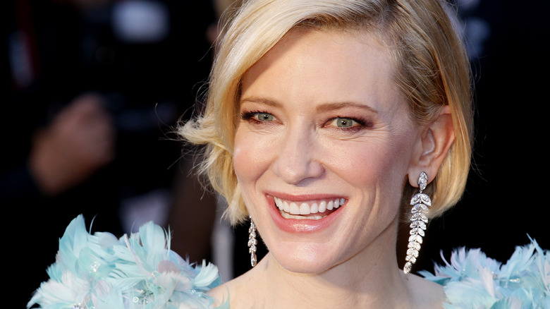 Cate Blanchett with leaf earrings, smiling