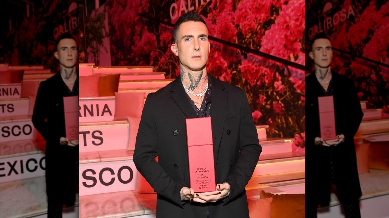 Adam Levine holding his tequila