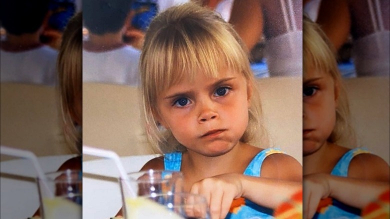 Cara Delevingne frowning as child 