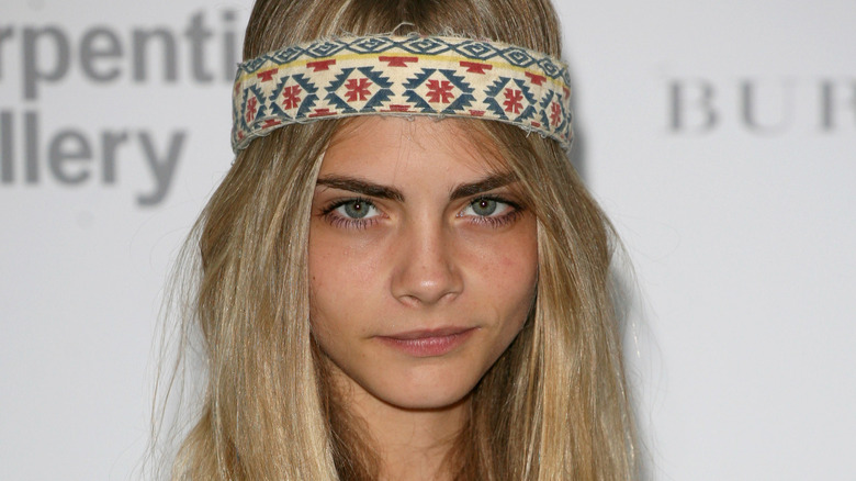 Cara Delevingne wearing headband smiling