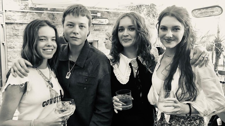 Emma D'Arcy, Olivia Cooke holding drinks