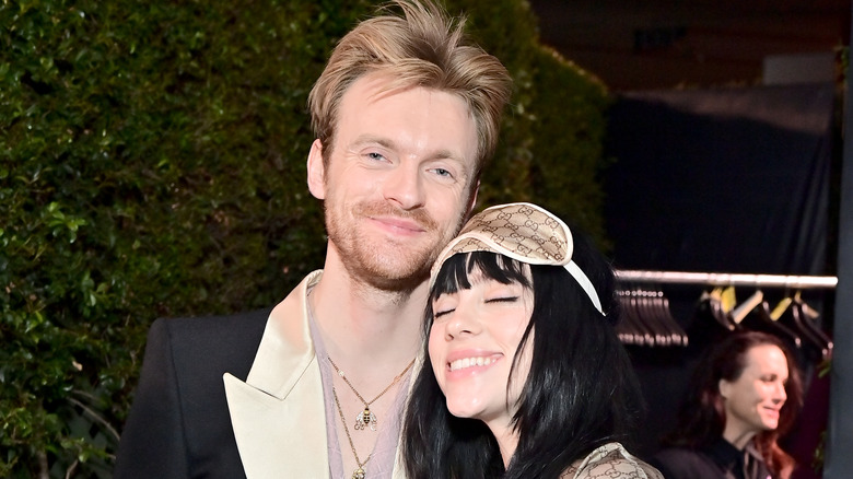 Finneas O'Connell and Billie Eilish smiling and posing together