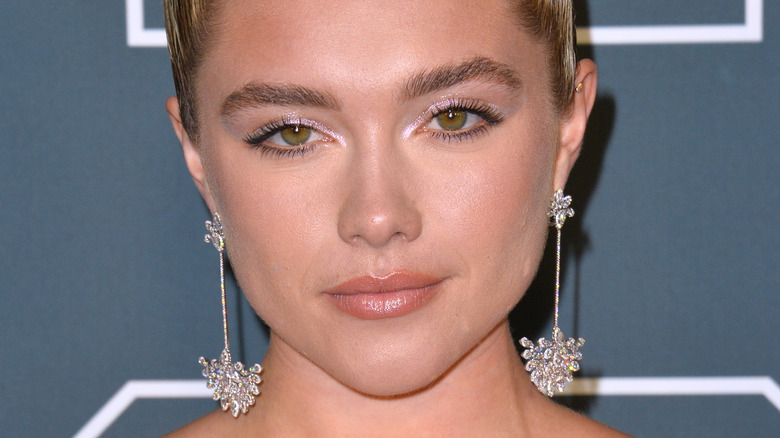 Florence Pugh wearing dangly, diamond earrings