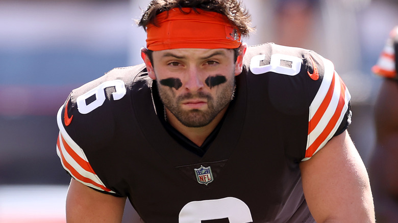 Baker Mayfield kneeling down on the field