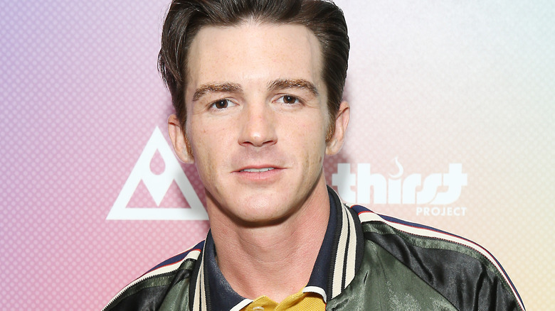 Drake Bell posing striped shirt