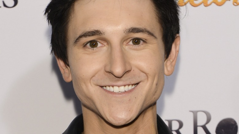A closeup of Mitchel Musso smiling
