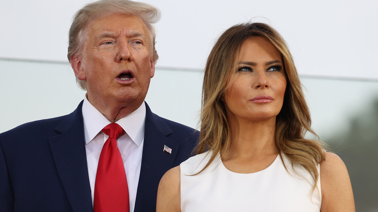 Melania Trump with Donald Trump behind her