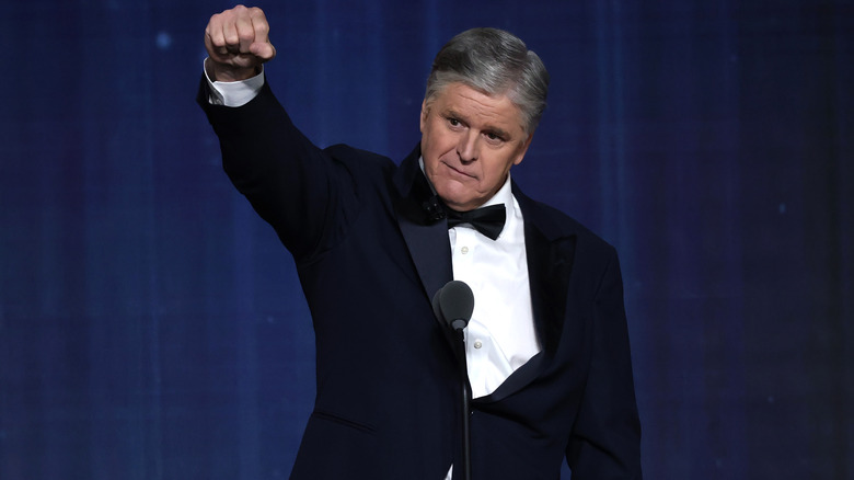 Sean Hannity raising his fist on stage.