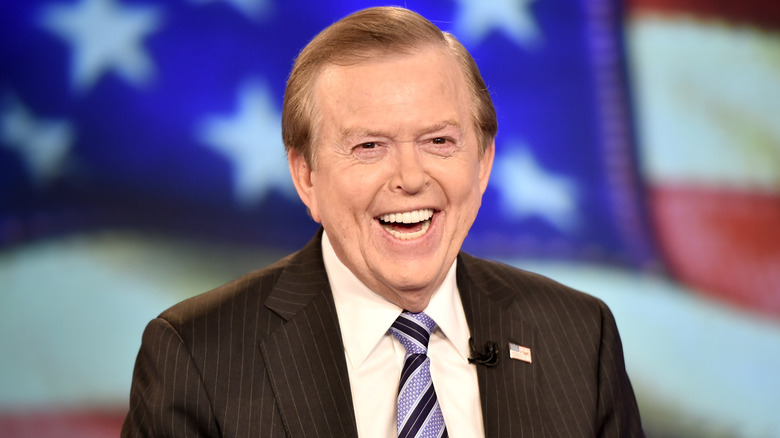 Lou Dobbs wearing a striped suit