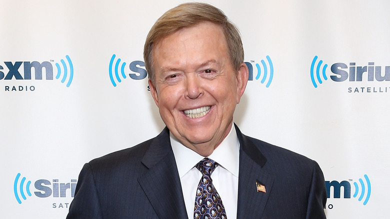 Lou Dobbs wearing a navy suit