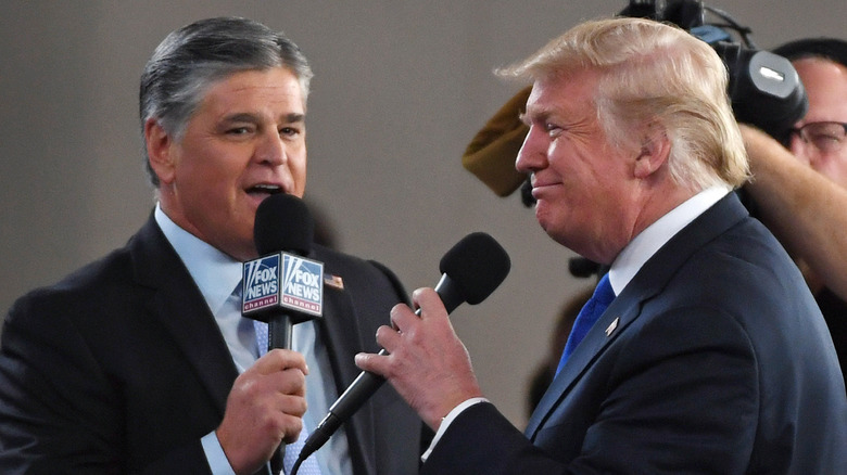 Sean Hannity and Donald Trump, speaking