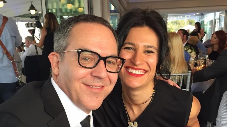 Greg Gutfeld and Elena Moussa pose during a wedding