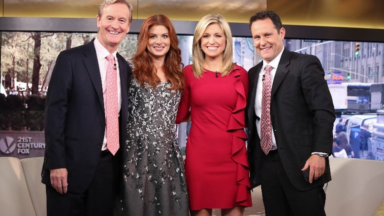 Steve Doocy, Debra Messing, Ainsley Earhardt, and Brian Kilmeade on the set of "Fox and Friends" (2014)