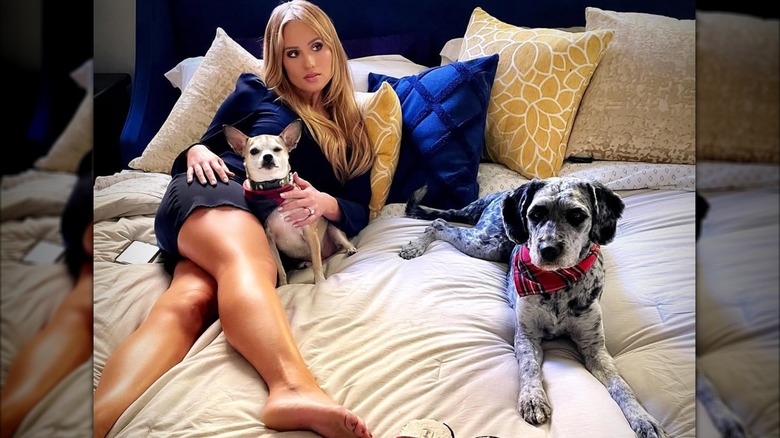 Tomi Lahren lying down with her dogs on a bed