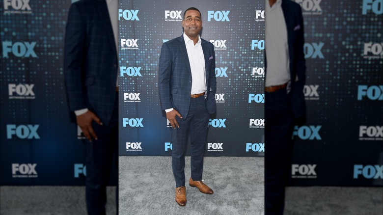 Cris Carter posing in suit