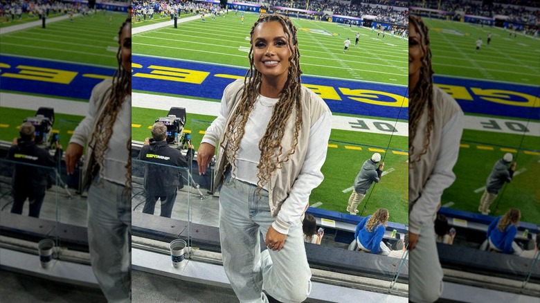 Joy Taylor posing at football game