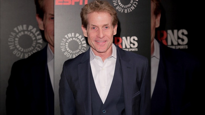 Skip Bayless posing in suit