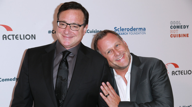 Dave Coulier leaning on Bob Saget's shoulder