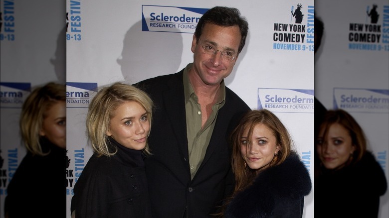 Bob Saget posing with Olsen twins