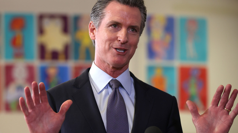 Gavin Newsom with his hands up