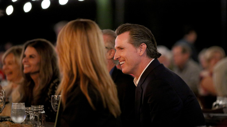 Gavin Newsom smiling at dinner