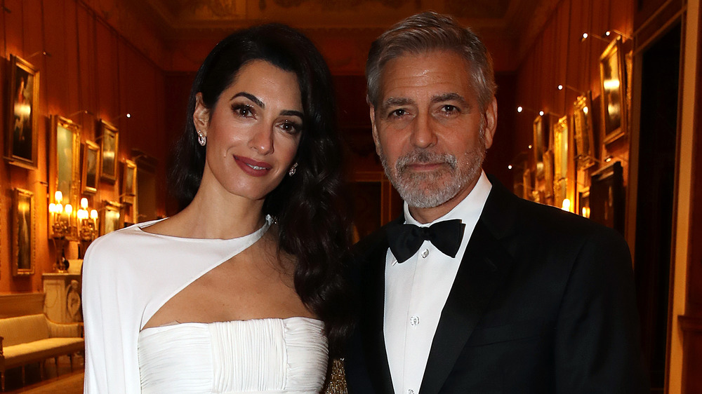 Amal and George Clooney at an event